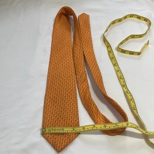 Men’s J.Crew tie 3 1/2 inches wide 100 % silk, orange with green accent color.